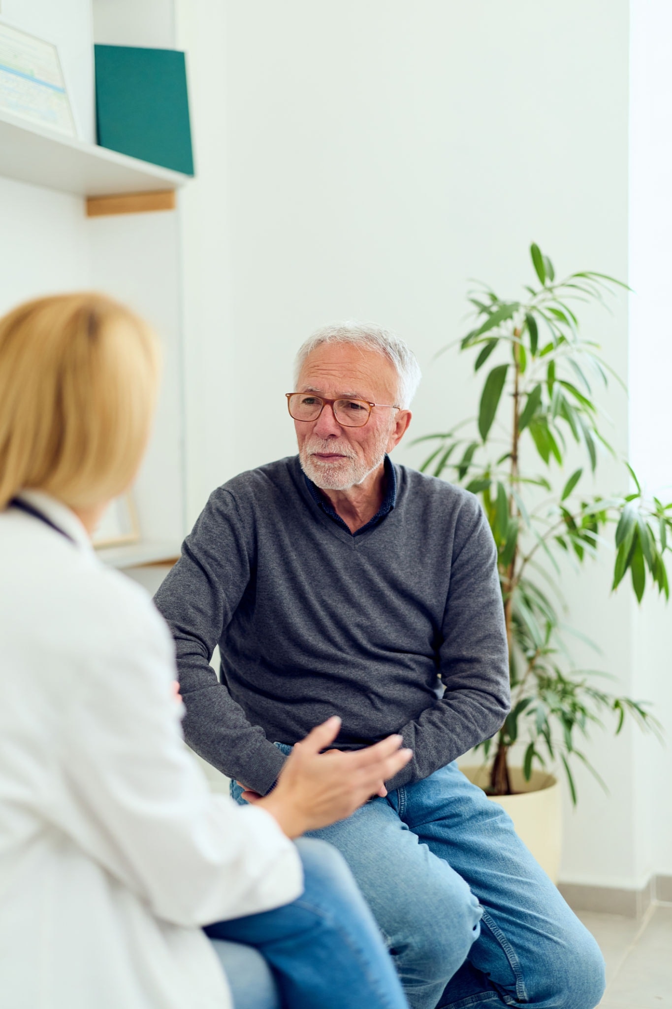 Doctor in compassionate patient consultation